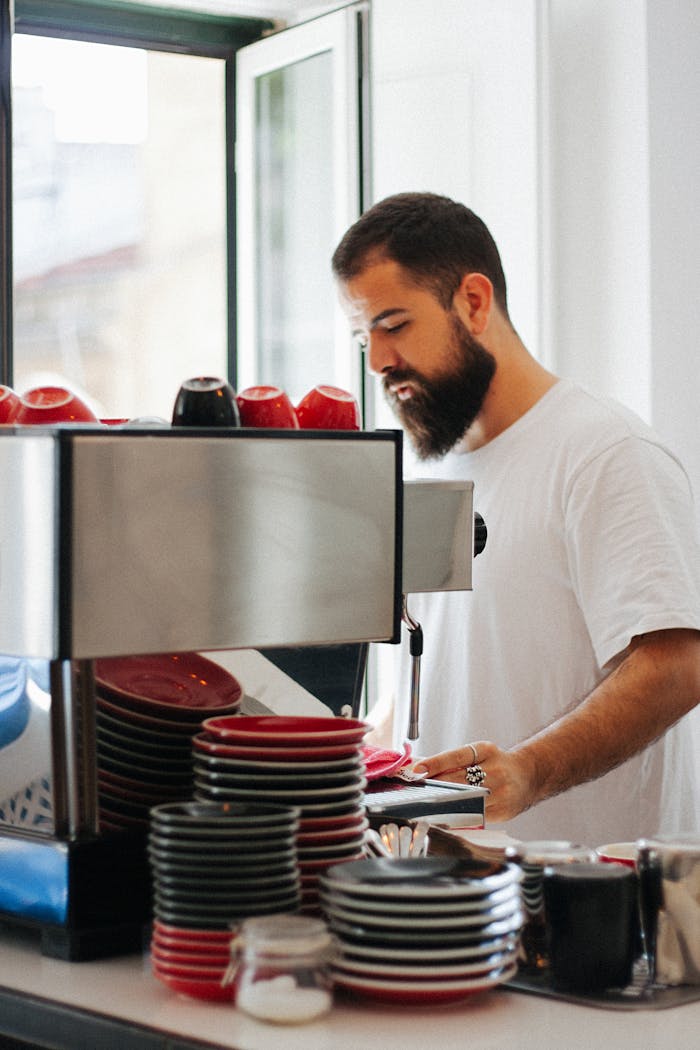 Barista skillfully making espresso in modern café, showcasing coffee preparation.