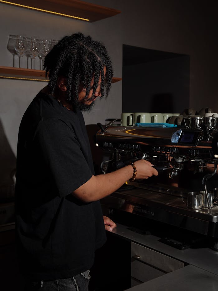 A barista prepares espresso using a machine in a stylish café, showcasing coffee culture.